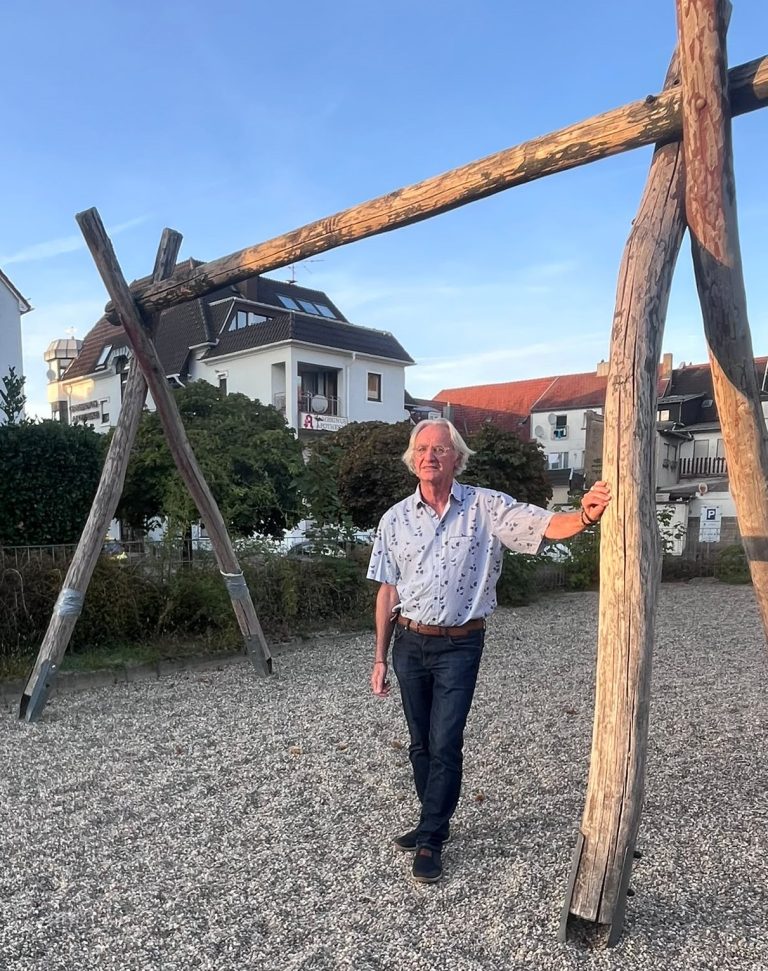 Franz-Josef Mast steht an einem Schaukelgestell ohne Schaukeln auf dem Spielplatz Kirchengasse